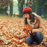 woman in fall leaves