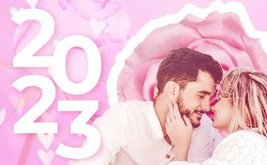 A couple is just about to kiss against a rosy background for the 2023 love horoscope.