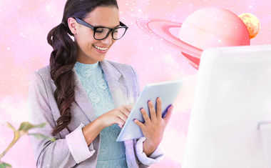 A woman works with a tablet against a pink planetary background.