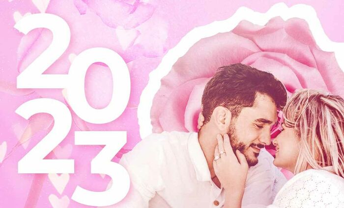 A couple is just about to kiss against a rosy background for the 2023 love horoscope.