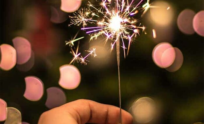 hand holding a sparkler on new years