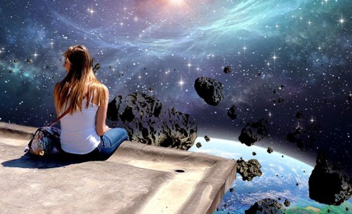 A woman sits on a precipice overlooking a cosmic scene.