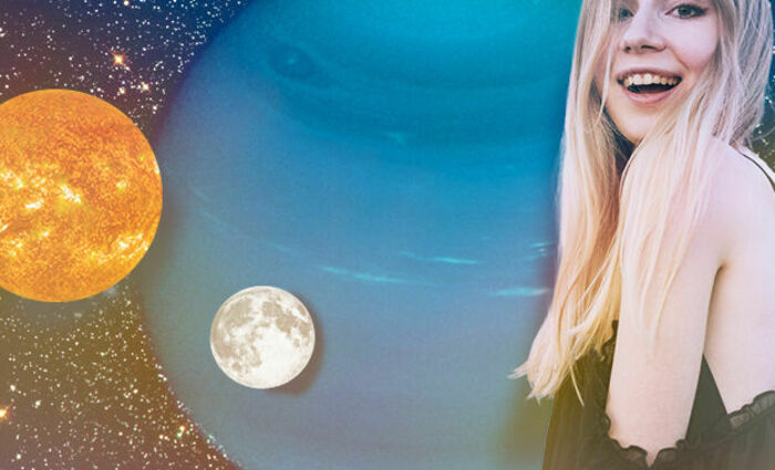 woman smiling next to planets