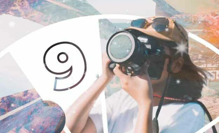 A person holds a camera to their face to take a picture, representing the 9th house in Astrology.