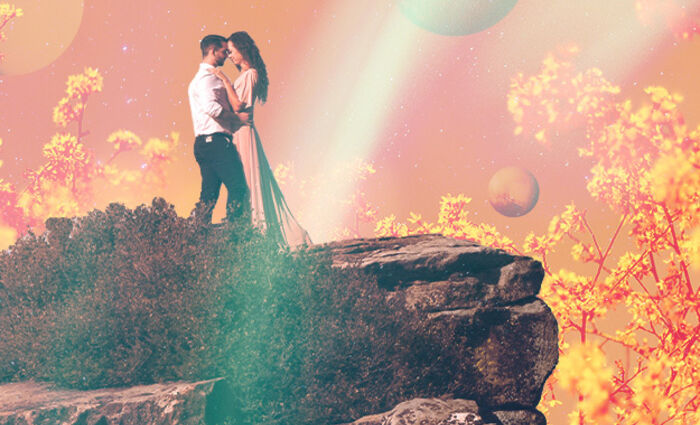 A couple embraces on a cliffside for the Leo 2023 love horoscope.