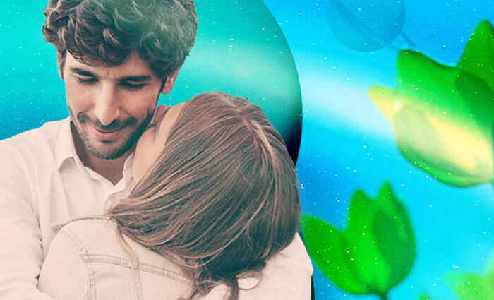 A couple hugs against a blue planetary background for the Virgo 2023 love horoscope.