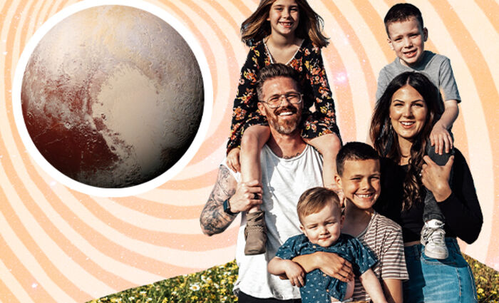 family smiling together with pluto in the sky
