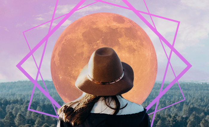 woman in front of pink moon supermoon