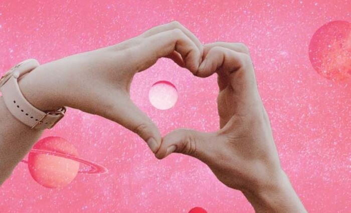 A couple making a heart with their hands, representing Tarot.com's Valentine's Day Horoscope