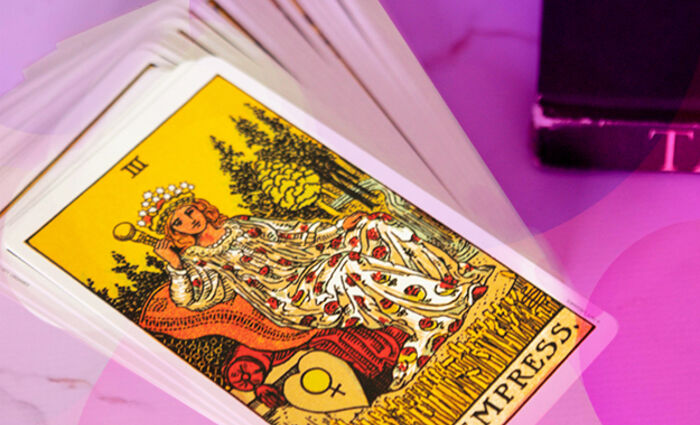 A Tarot deck sits on a table, with The Empress on top.