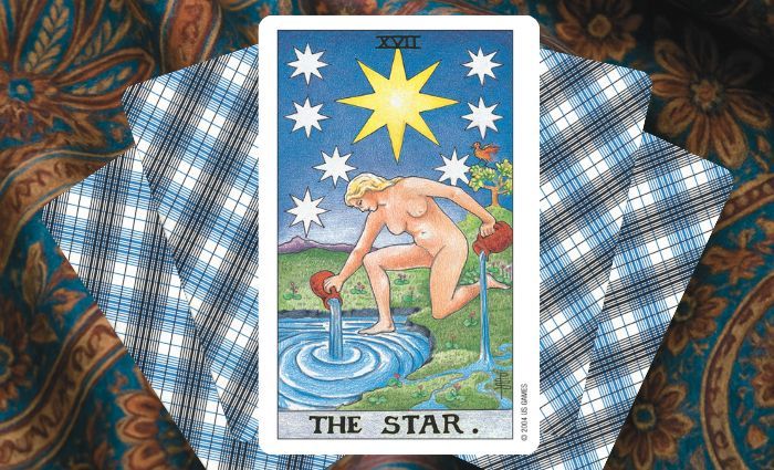 A classic Star card rests on a floral tapestry.