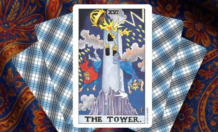 A classic Tower card rests on a floral tapestry.